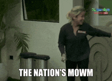 a woman is standing in front of two trash cans and says the nation 's mowm