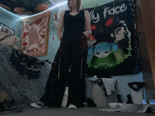 a woman stands in front of a wall with a tapestry that says my face
