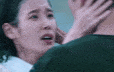 a man is touching a woman 's face with his hand and she is crying .