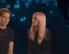 a man and a woman are standing next to each other with glowing stars in the background