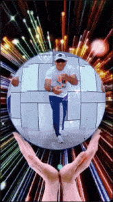 a person holding a disco ball with a man in the background