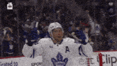 a hockey player wearing a jersey that says toronto maple on it
