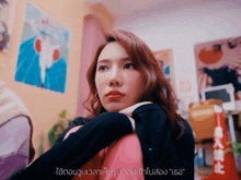 a woman in a room with chinese writing on the bottom right