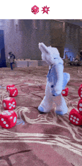 a stuffed animal in a bunny costume is walking around red dice on a carpet