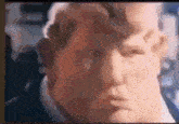 a close up of a man 's face with a blurry background