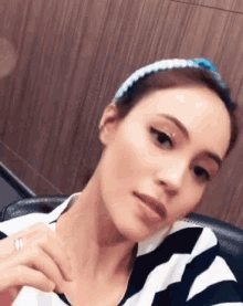 a woman wearing a headband and a striped shirt
