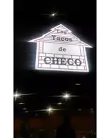 a car parked in front of a tacos checo restaurant