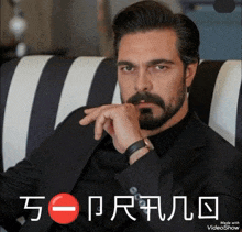 a man with a beard is sitting on a striped chair with the words made with videoshow on the bottom right