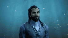 a man with a beard is holding a purple cup in his hand in a dark room .