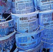 a stack of blue newspapers with chinese writing