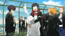 a group of people are standing around a fence and a girl is holding a ghost