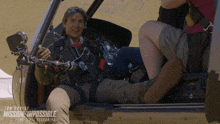 a man is sitting in a helicopter with the words mission impossible on the bottom