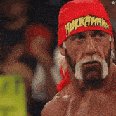 hulk hogan is wearing a red headband with the word hulk on it
