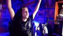 a person with their arms in the air in front of a jukebox that says ' rock ' on it