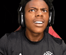 a young man wearing headphones and a shirt that says be world ready