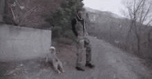 a man is walking a dog on a leash down a road .