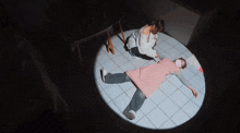 a woman in a pink apron is laying on the floor while another woman looks on