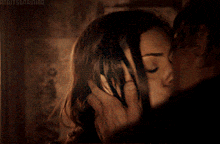 a man and a woman are kissing in a dark room with the word andy screaming at the bottom