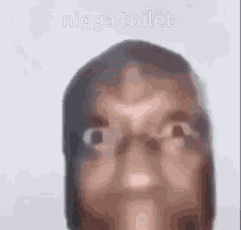 a close up of a person 's face with the words nigga toilet written below it