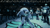 a man in a number 59 jersey stands on a basketball court