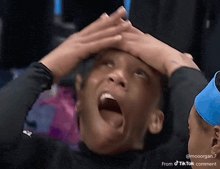 a person with their hands on their head has a tiktok comment on the bottom