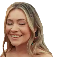a close up of a woman 's face with her eyes closed smiling