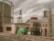 a green van is parked on the train tracks