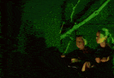 a man is holding a fireball in his hands in front of a green wall .
