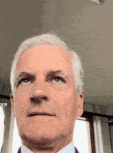a close up of a man 's face in front of a screen that says ore