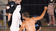 a man in a wrestling ring with his fist up