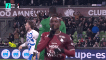 a soccer game is being played in front of a banner that says " club "