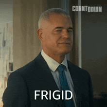 a man in a suit and tie says frigid in front of a countdown sign