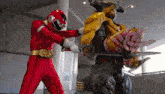 a red power ranger is fighting a yellow monster