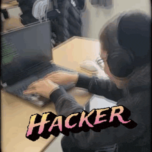 a person wearing headphones is typing on a laptop and the word hacker is visible