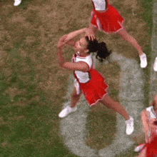 cheerleaders wearing red uniforms with the word glee on the front