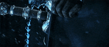 a person is holding a sword with a chain around it that says ' ice ' on it