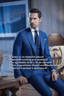 a man in a blue suit and tie sits on a wooden bench