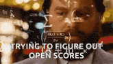 a man in a suit and tie is looking at a screen that says " trying to figure out open scores "