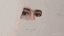 a drawing of a woman 's face is being made in an animated video