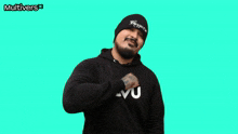a man wearing a beanie and a sweatshirt that says multivers applauds