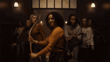 a group of young women are dancing in a room and one of them is wearing a sweatshirt that says hartford .