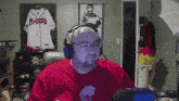 a man wearing headphones and a braves jersey