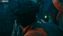 a man talking to another man with a xtoms1205 watermark on the bottom right