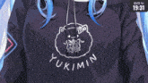 a girl with blue hair is wearing a yukimin hoodie