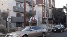 a man is sitting on top of a silver limousine