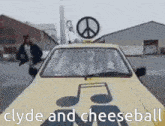 a yellow car with a peace sign on top of it