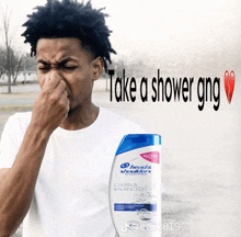 a man holding his nose next to a bottle of head & shoulders