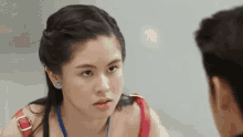 a woman is looking at a man in a mirror and making a face .