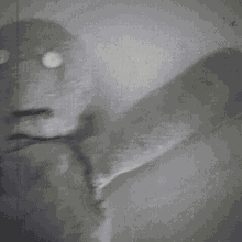a black and white drawing of a ghostly figure with glowing eyes and a tongue sticking out
