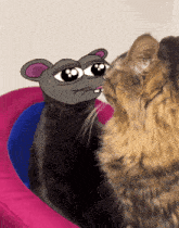 two cats are looking at each other with a drawing of a mouse on one of them